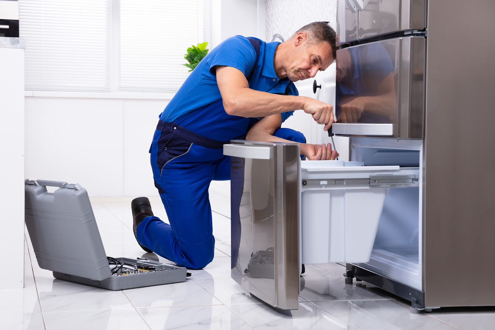 GRIT Technician Repairing Refrigerator